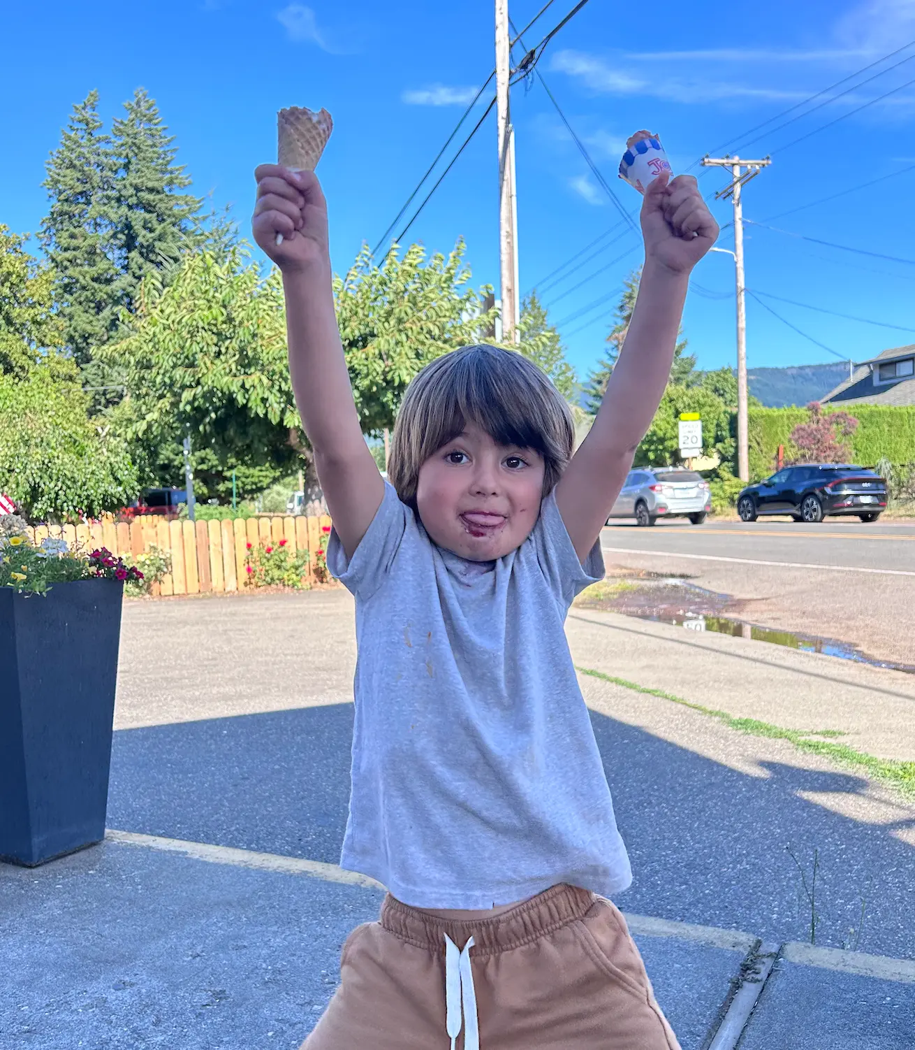 Kye celebrating with ice cream cones raised in the air